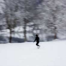 Black woman running across snow-filled landscape