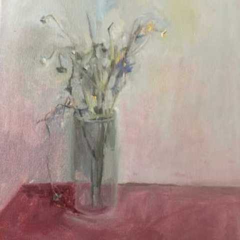 Vase of flowers on a pink table top