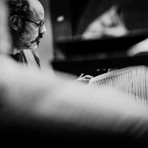 B&W profile image of composer Zad Moultaka with some sheet music