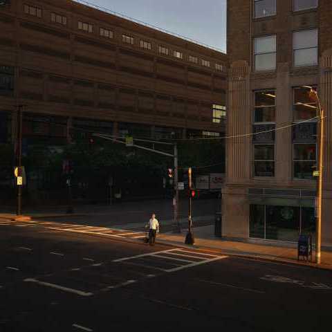 Oli Kellett Men crossing street lonely figure