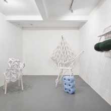 Installation of contemporary shapes, almost tube like sculptures in white, blue and dark green